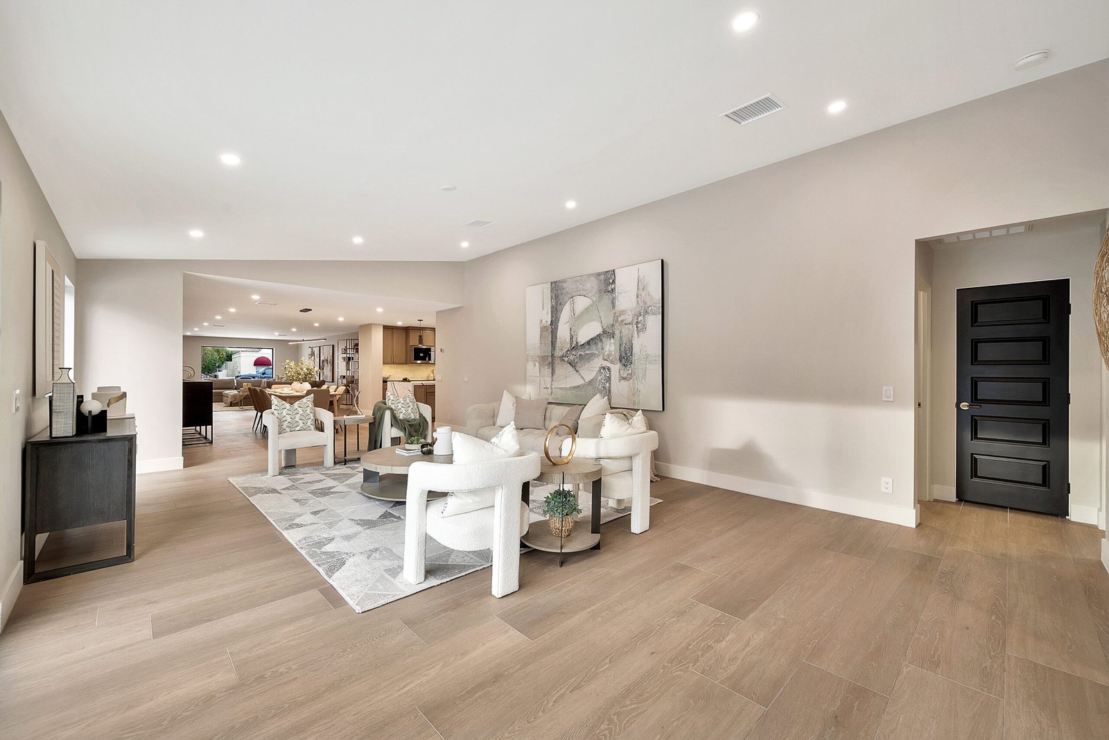 Flooring Open kitchen and dining area with continuous light wood-look plank flooring