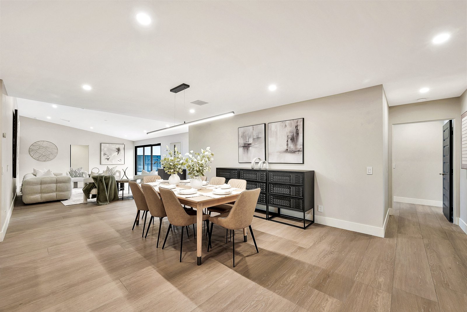 Flooring Light-toned flooring through an open living and dining space, connecting the living and dining rooms